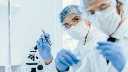 close up. group of scientists in protective clothing working in the laboratory.