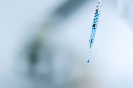 close up. monochrome image of a syringe with a vaccine in the hands of a doctor .の写真素材