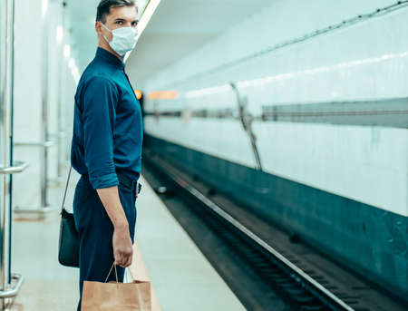 passengers in protective masks waiting for the metro trainの写真素材