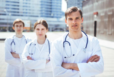 group of medical professionals standing on a city street.