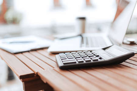 close up. calculator and laptop on a wooden tableの写真素材