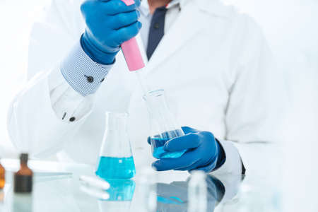 close up. a scientist using an automatic dispenser for testing.の写真素材
