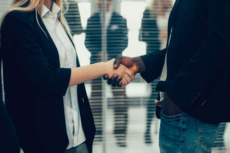 close up. young business partners shaking hands.