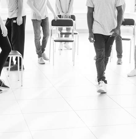 handsome guy confidently passing through a spacious office.の写真素材