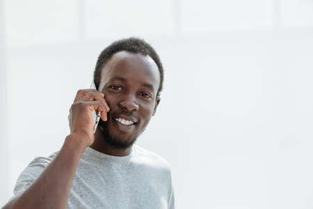 side view. stylish young man talking on his smartphone.