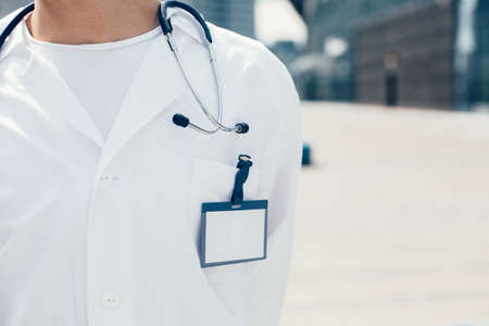 close up. male paramedic with a badge on his white coat.の写真素材