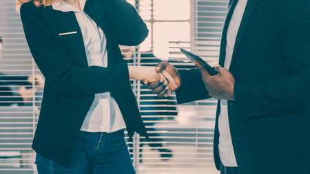 young business colleagues shaking hands with each other.の写真素材