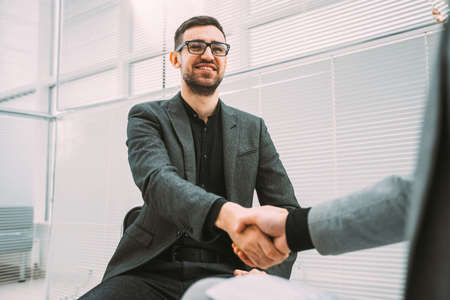 business man meeting his business partner in the office lobby.の写真素材