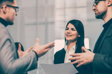 smiling business partners shaking hands with each other.の写真素材