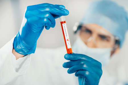close up. test tube in the hands of a laboratory assistant.