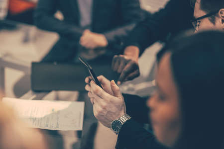 close up. employees using their smartphone to view new information.の写真素材