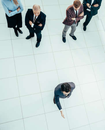 top view. leader standing in front of a group of employees.