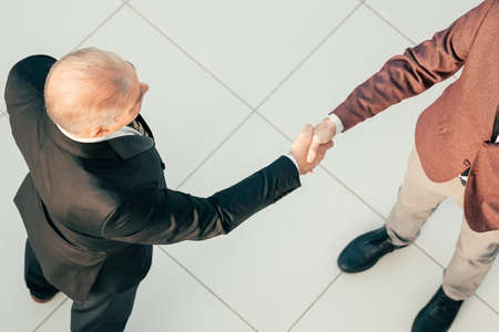 top view. businessman shaking hands with his business partner.の写真素材