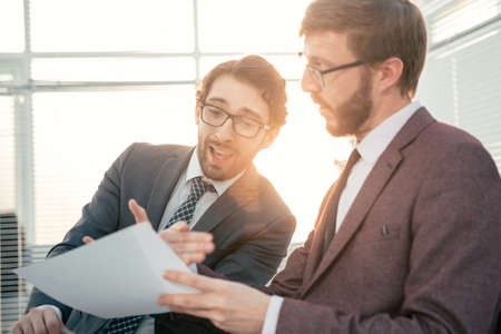 two business men discussing a business document.の写真素材
