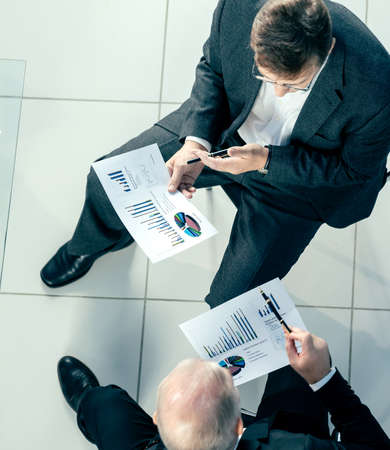 top view. business colleagues shaking hands in agreement.の写真素材