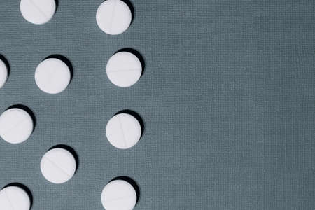close up. lot of pills on a dark green background.