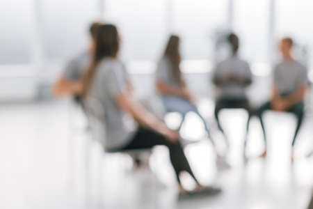 background image of a group of young people sitting in a circleの写真素材