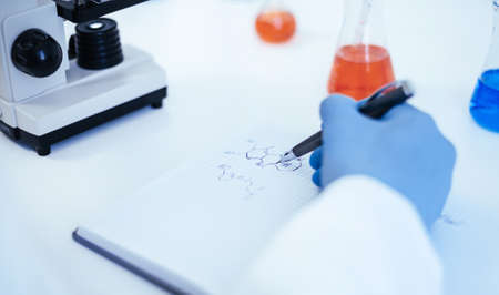 close up. scientist looking at a drop of blood through a microscope.の写真素材