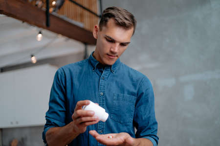 young men taking pills. concept of health protection.の写真素材