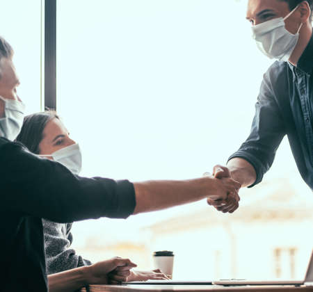 close up. financial partners are shaking hands with each other .の写真素材