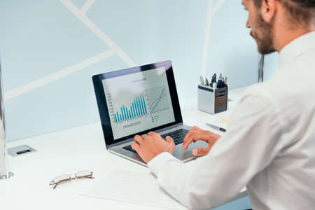 business man using a laptop to analyze financial data .の写真素材