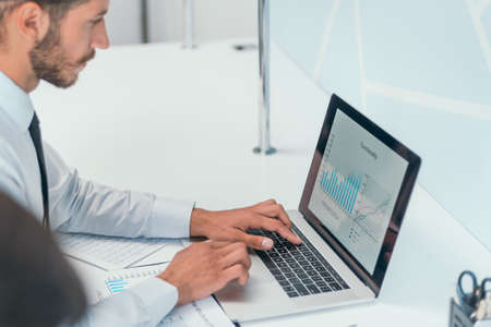 close up. serious business man is working on his laptop in the office.の写真素材