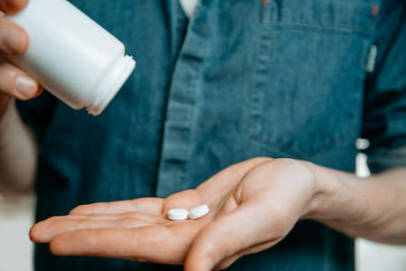 close up. two tablets in the palm of a persons hand.の写真素材