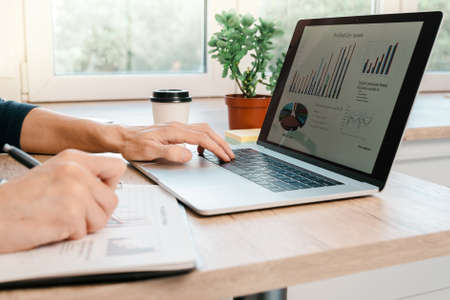 close up. man using a laptop to analyze financial charts.の写真素材