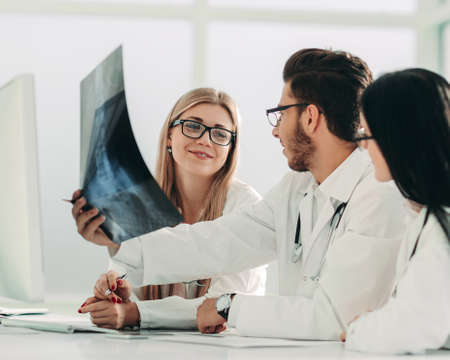 radiologist and his colleagues discuss the x-ray of the patient