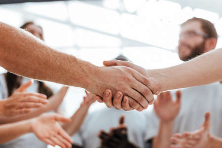 close up. handshake of two students on the background of the st