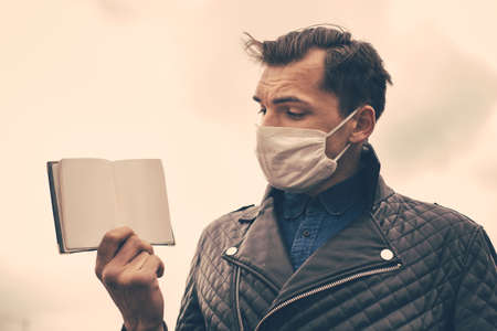 close up. a man in a protective mask presenting his passport.の写真素材