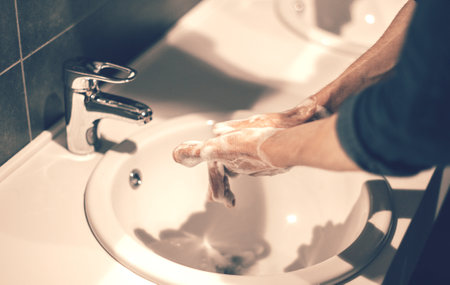 close up. young man soaping his hands under the tapの写真素材