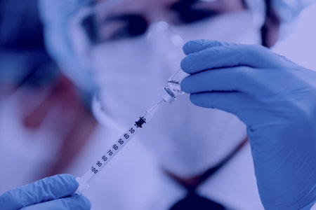 close up. scientist filling the syringe with the new vaccine .の写真素材