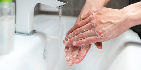 close up. modern guy carefully lathering his hands .の写真素材