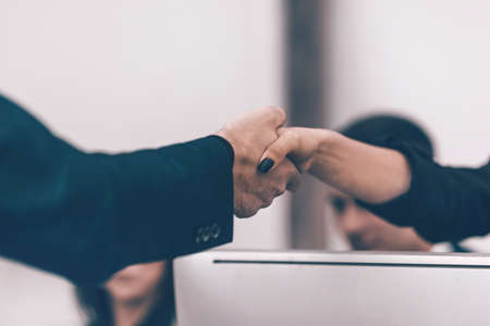 close up. businessman and businesswoman shaking hands