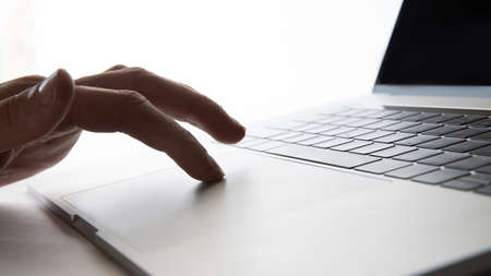 close up. man using a laptop touchpad.