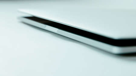 image of a slightly open laptop on a light background.の写真素材