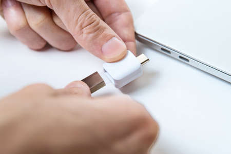 Man uses modern technologies to store memory and digital data. type-c