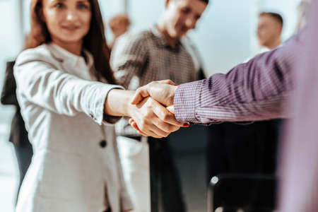 close up. young casual business people shaking hands with eachの写真素材