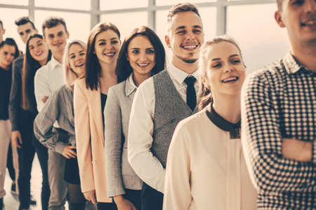 group of diverse young people standing in a long queue