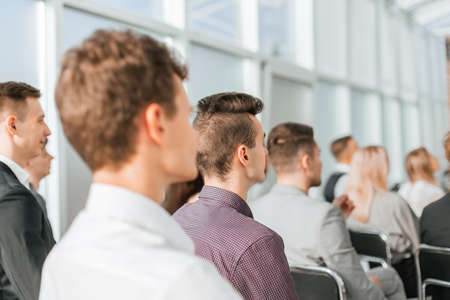 young people listening to the speaker at the business seminarの写真素材