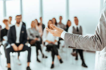 background image of a speaker standing in front of listeners in a conference roomの写真素材
