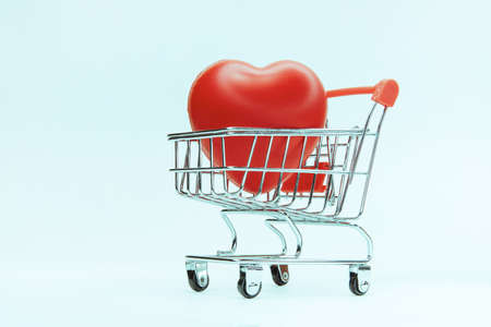 close up. big red heart in a shopping cart.