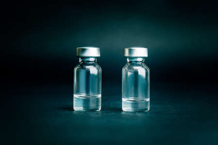 close up. two medical ampoules on a dark background.の写真素材