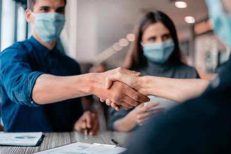 close up. financial partners are shaking hands with each other .の写真素材