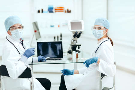 close up. medical colleagues sitting at a table in the laboratory .