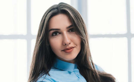 young business woman on the background of an office windowの写真素材