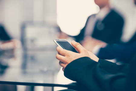 close up. businessman with a smartphone sitting at an office Desの写真素材