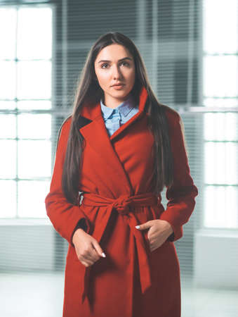 beautiful young woman standing in front of an office buildingの写真素材