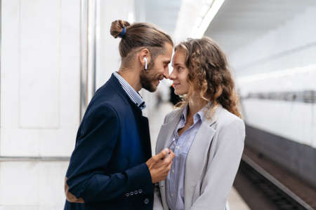 beautiful couple standing on the subway platform.の写真素材